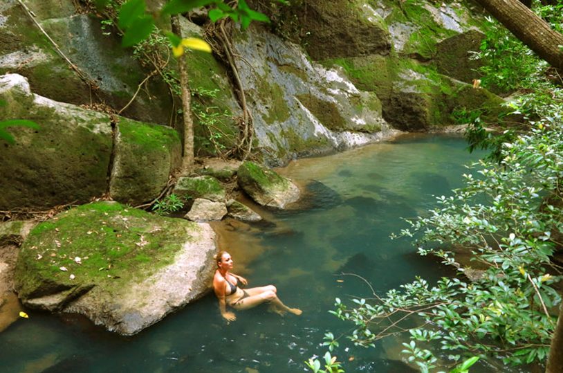 A woman relaxes in a hot spring in a 600-acre private reserve on AdventureWomen trip to Costa Rica