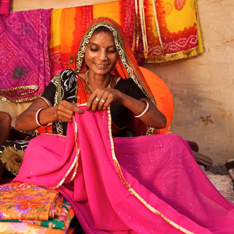 Indian woman selling colorful fabrics in advance of Holi festival