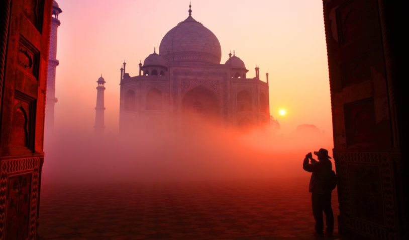The Taj Mahal wrapped in the glow of a beautiful orange sky at sunset