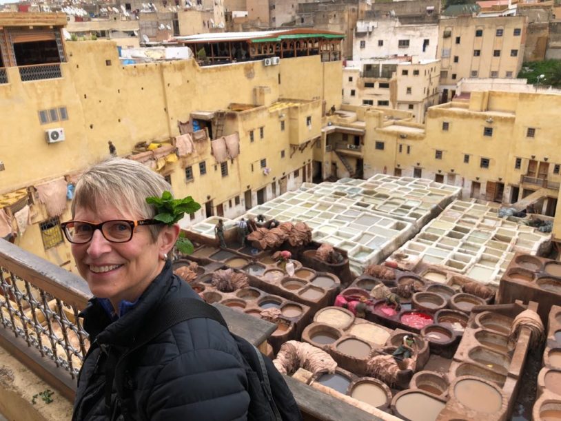 A women visiting the ancient tannery dye vats at Fes, Morocco with AdventureWomen