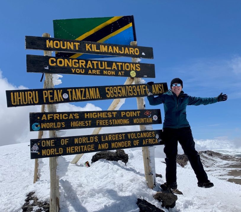 An Adventure Woman at Uhuru Peak on Kilimanjaro Summit at Uhuru Peak