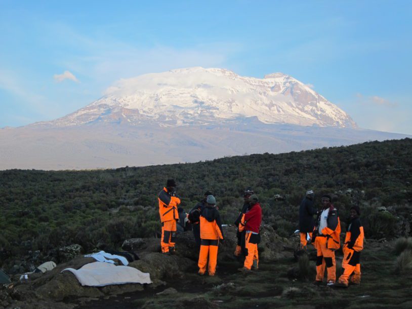 Stunning view of hikers in gear as they get closer to Mt Kilimanjaro