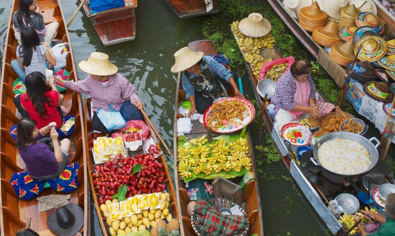 Women sell food from boats at the floating market in Damnoen Saduak, Thailand on AdventureWomen trip to Thailand.