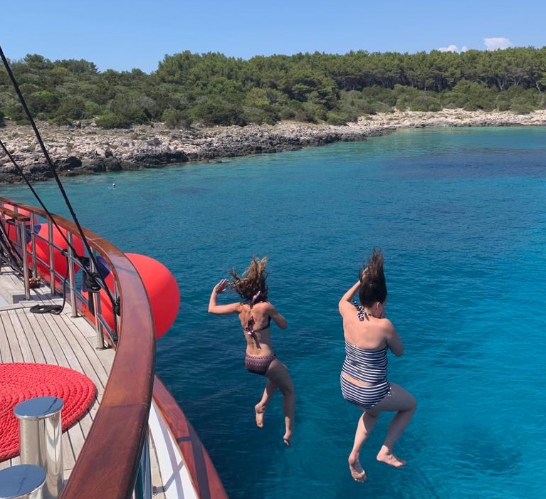 Adventure Women jumping into the Adriatic Sea