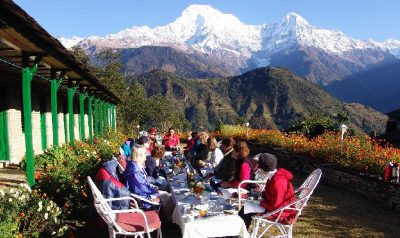 Breakfast outdoors at Himalayan Lodge surrounded by spectacular mountains