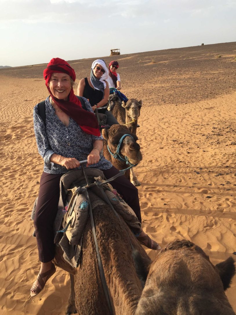 Camel Ride with a smiling AdventureWoman guest