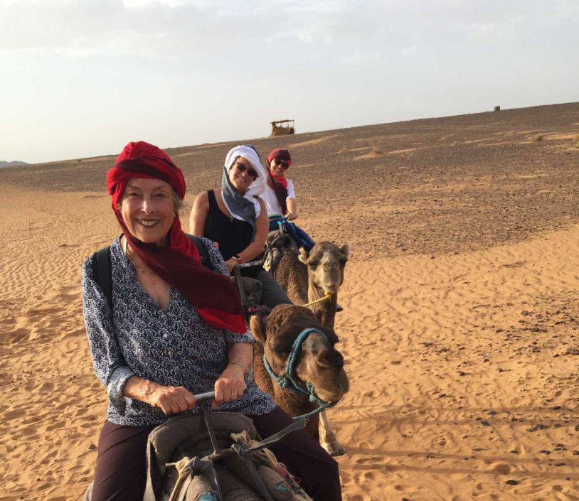 Camel Ride with a smiling AdventureWoman guest