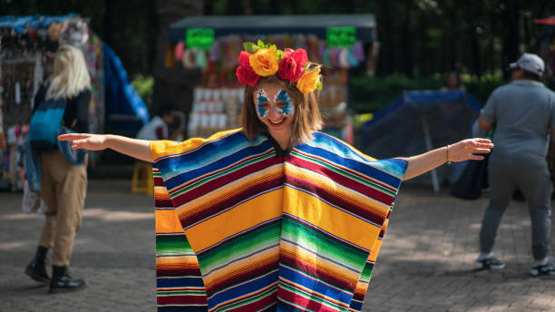 Young girl smiling in costume for Dia de Muertos