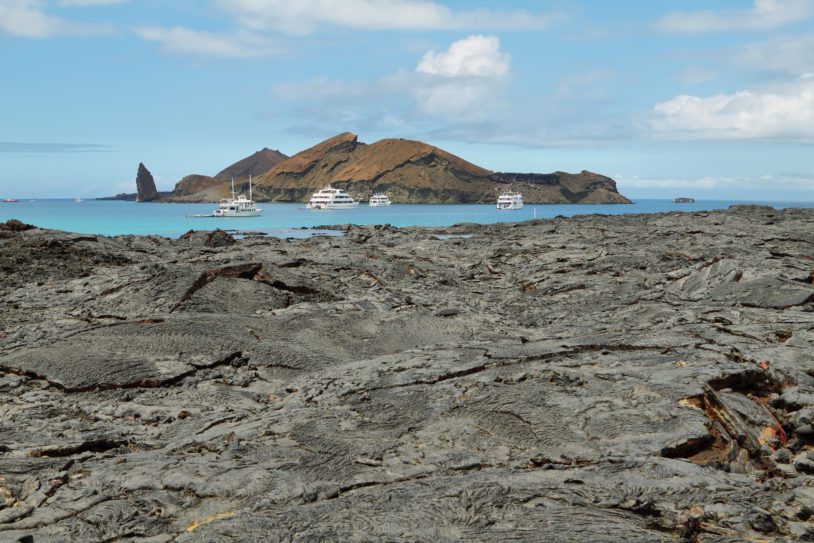 Volcanic landscape of Santiago island with Bartolome island at background, Galapagos, Ecuador