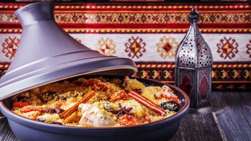 Traditional moroccan tajine of chicken with dried fruits and spices, selective focus.