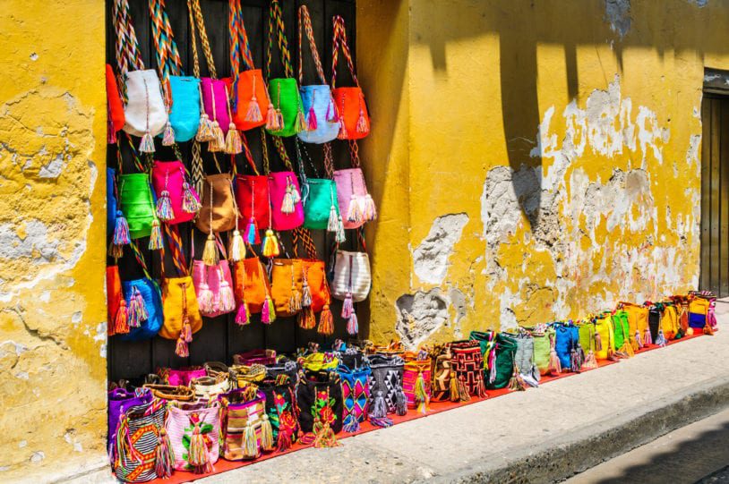 Colorful bags of all shapes and sizes adorn the stoned streets women trips