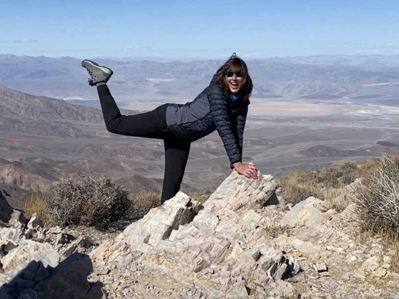 A guest striking a fun pose on Death Valley rocks
