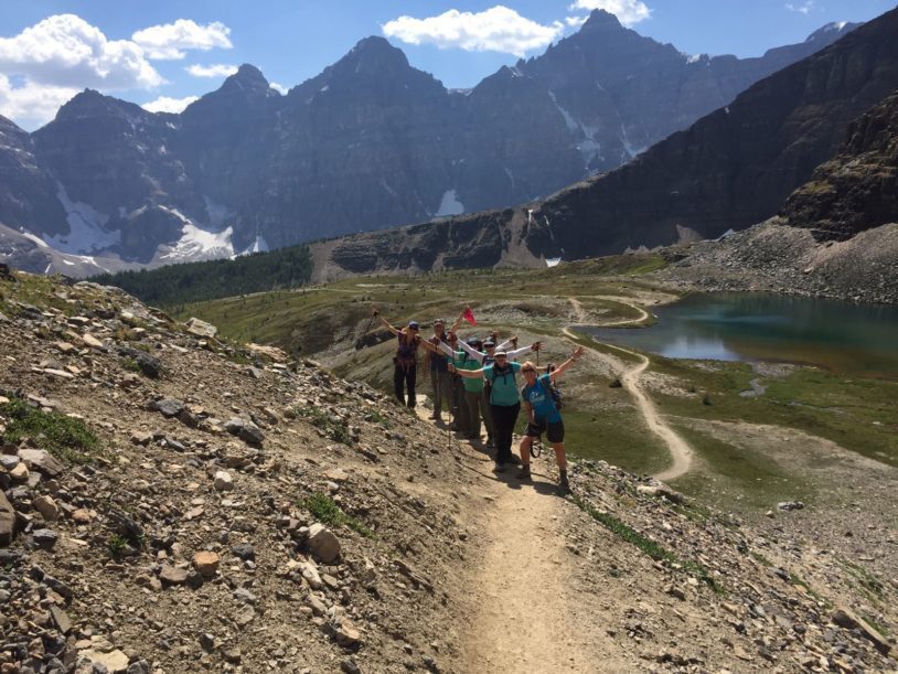 Small group of women hiking Sentinal Pass with the Candian Rockies in the background