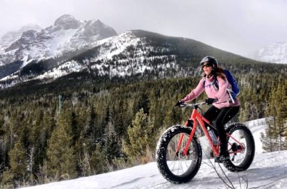 Woman trying fat biking on mountain snow