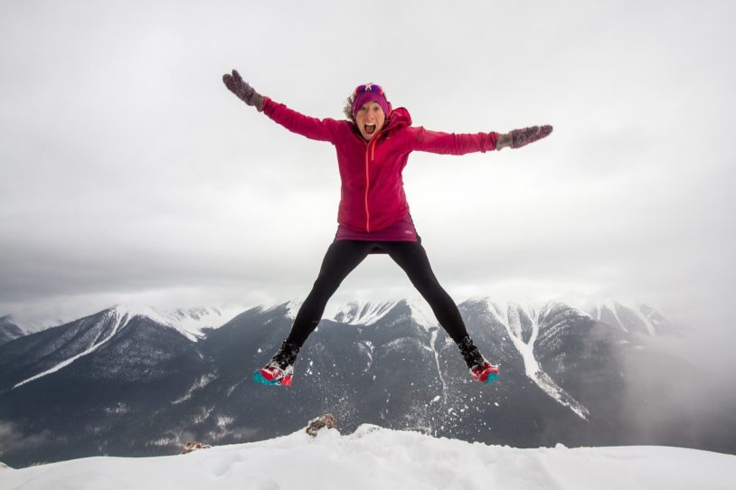 Women jumping high outside in the snow for fun