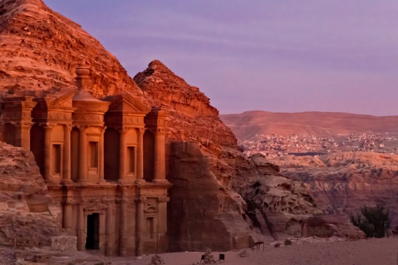 The famous Ad Deir, often also refered to as Monastery, in the ancient nabbatean city of Petra in Jordan at sunset with a view to the city of Wadi Musa.