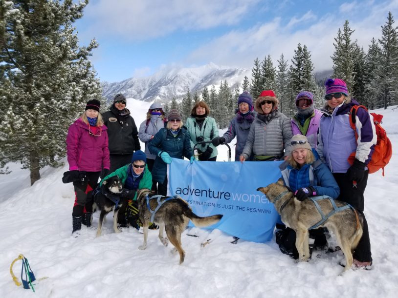 Adventure Women Group with flag and dogs