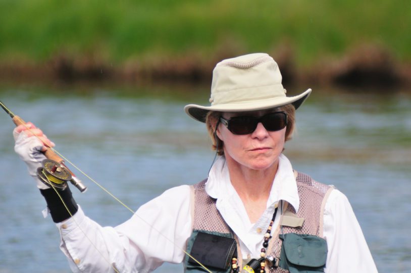 Close up of a women intently fly fishing