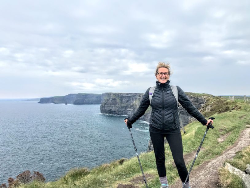 Posing for a picture next to the Cliffs of Moher in hiking gear